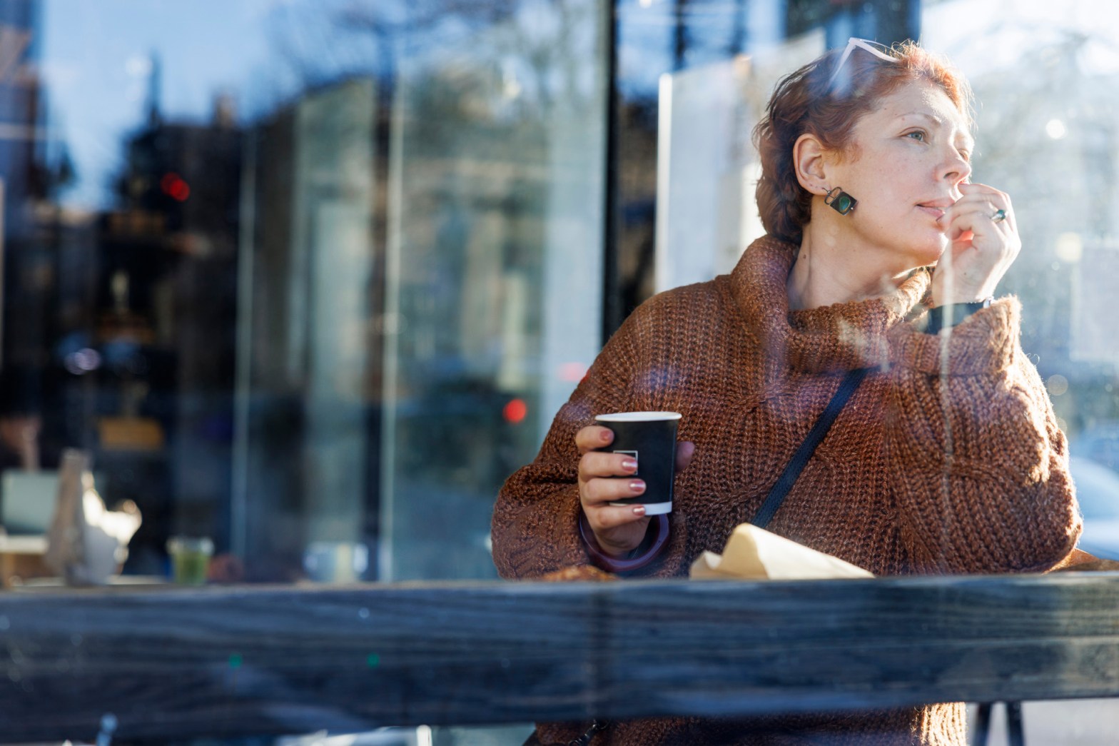 Woman in coffee shop feeling restless, looking for something