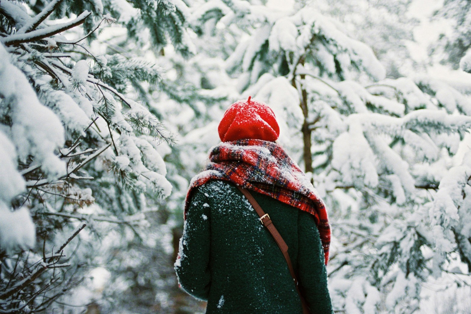Woman walking through the winter forest