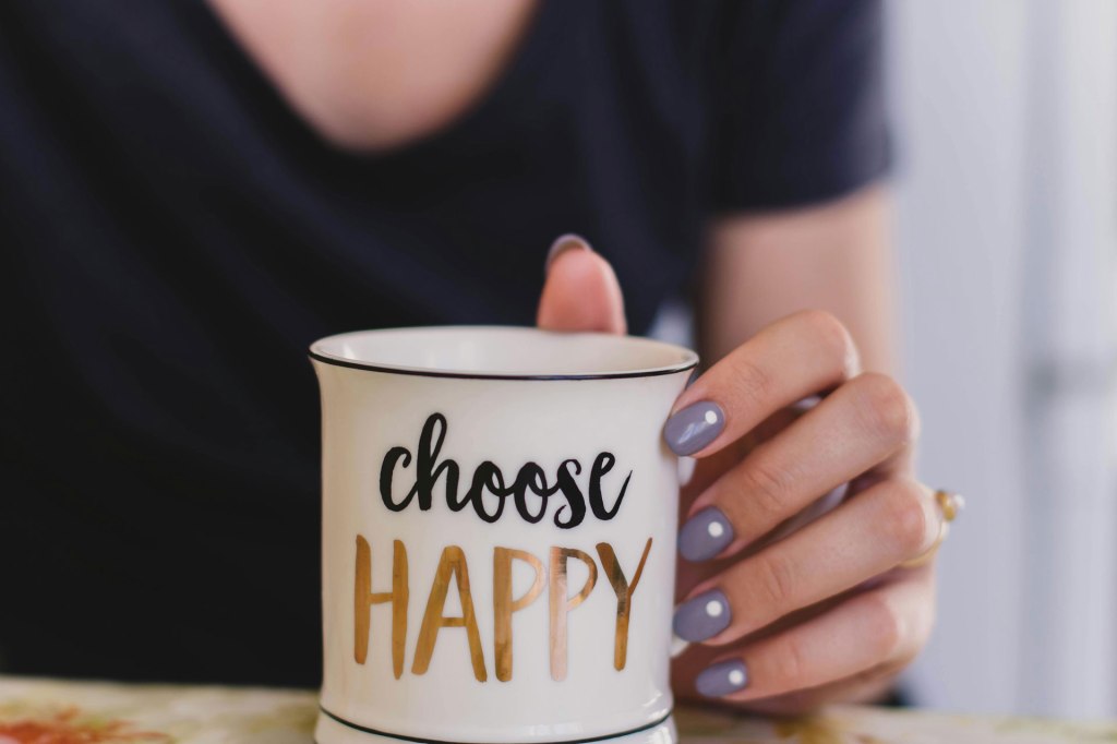 Woman holding coffee mug 'Choose Happy'