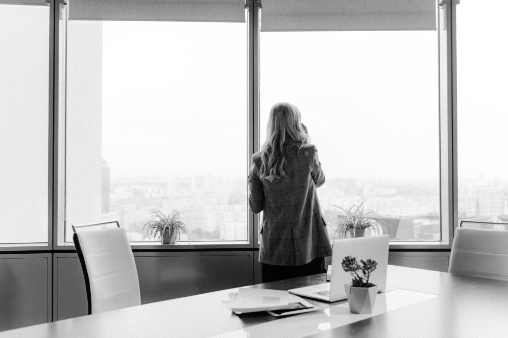 Woman standing by an office window